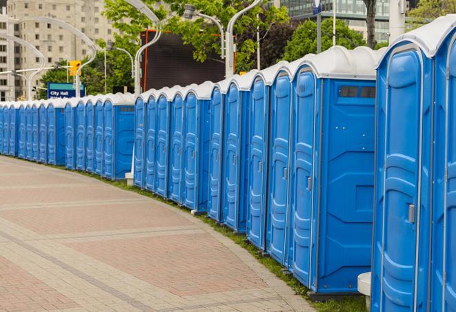 a row of portable restrooms set up for a special event, providing guests with a comfortable and sanitary option in Broadway